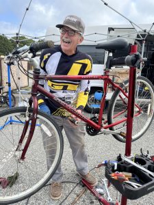 Bill Trimble of Youth Opportunities Unlimited repairing a bicycle.